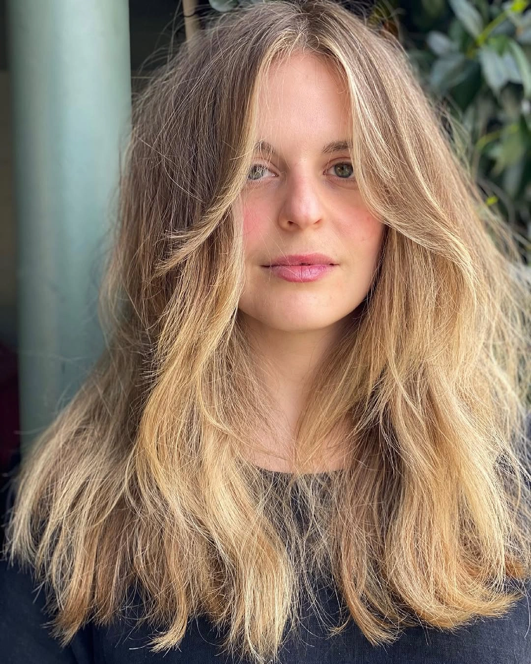 Long blonde middle part waves with soft face framing pieces