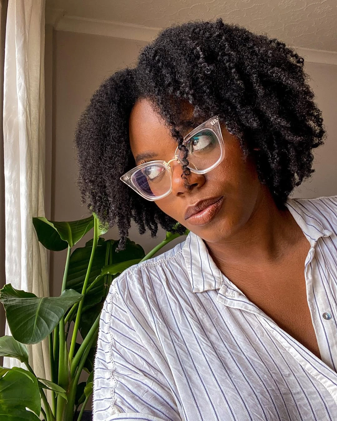 Rounded dark curls arranged around a middle part