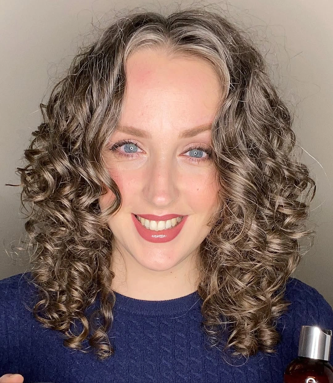 Shoulder length defined curls with a centered middle part