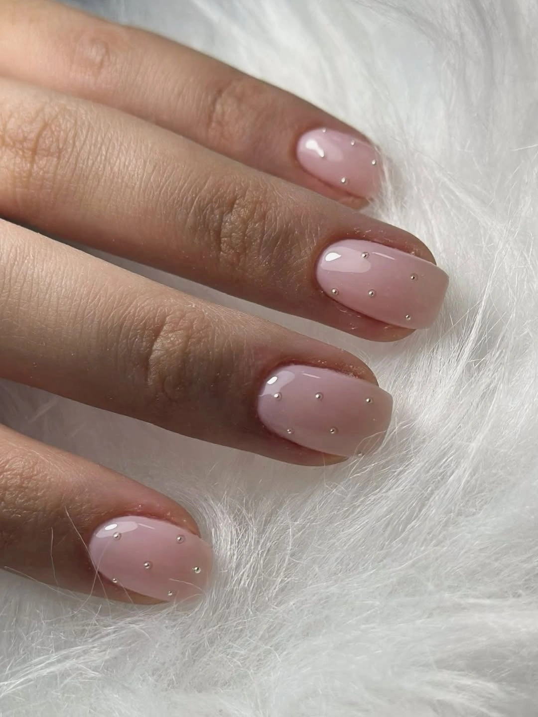 Short nude pink squoval nails with tiny scattered dot details