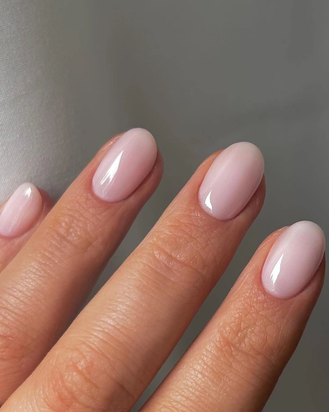 Short oval nails in very pale pink with simple even color