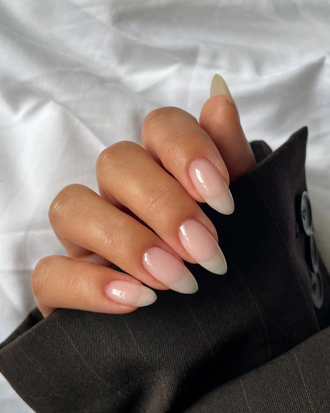 Medium sheer warm nude almond nails with soft pink transition