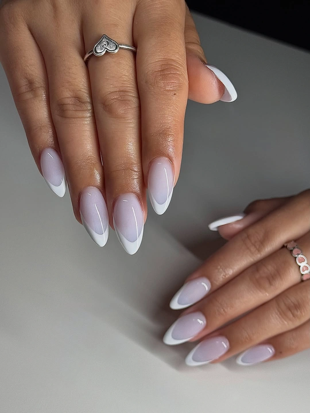 Long nude pink almond nails fading softly to white tips