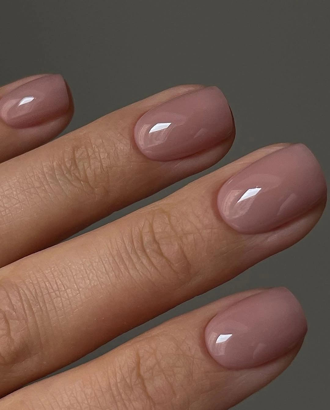 Short rounded square nails in a muted mauve nude color