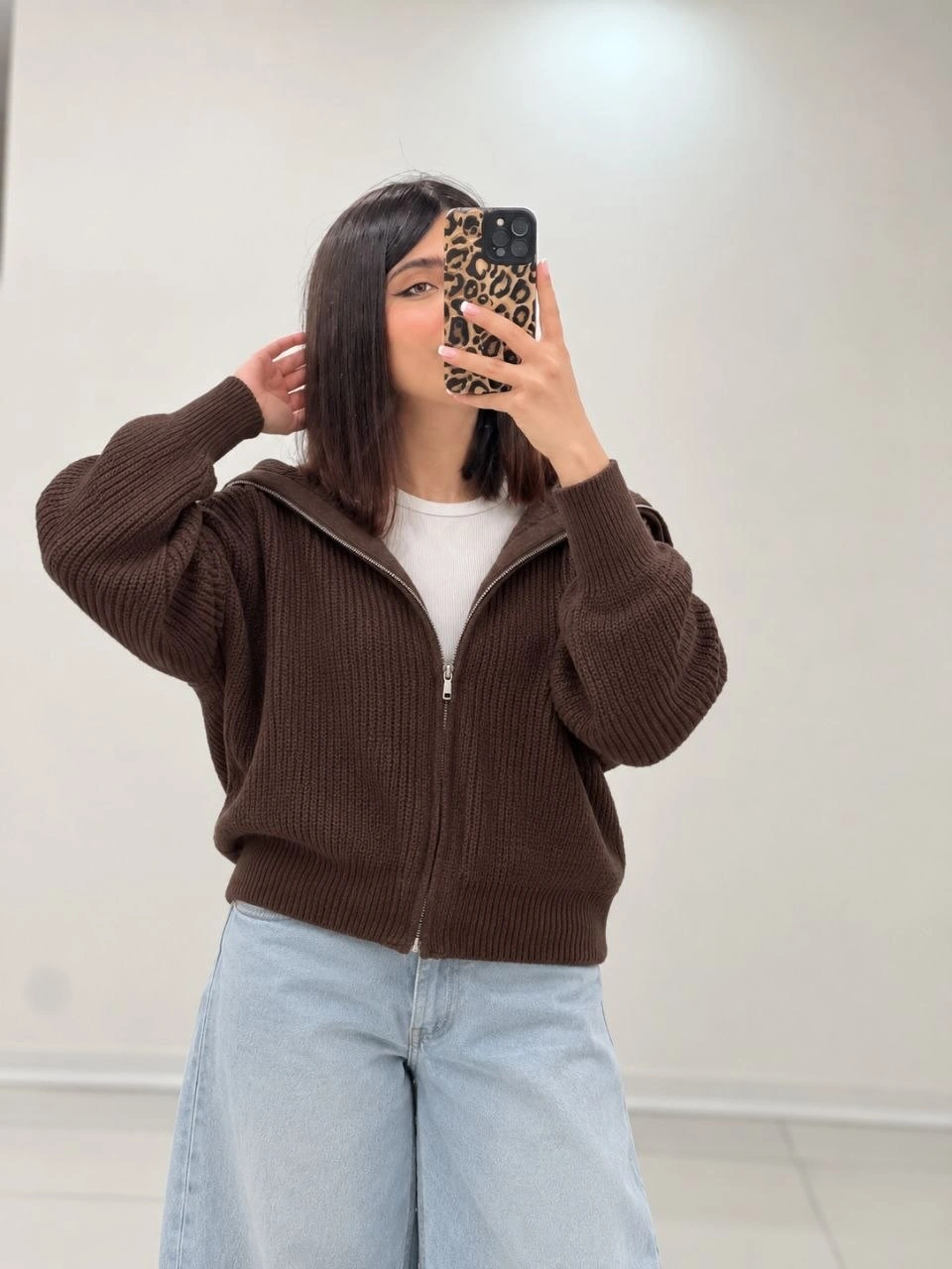 Chocolate ribbed zip cardigan over white tee with pale wide-leg jeans