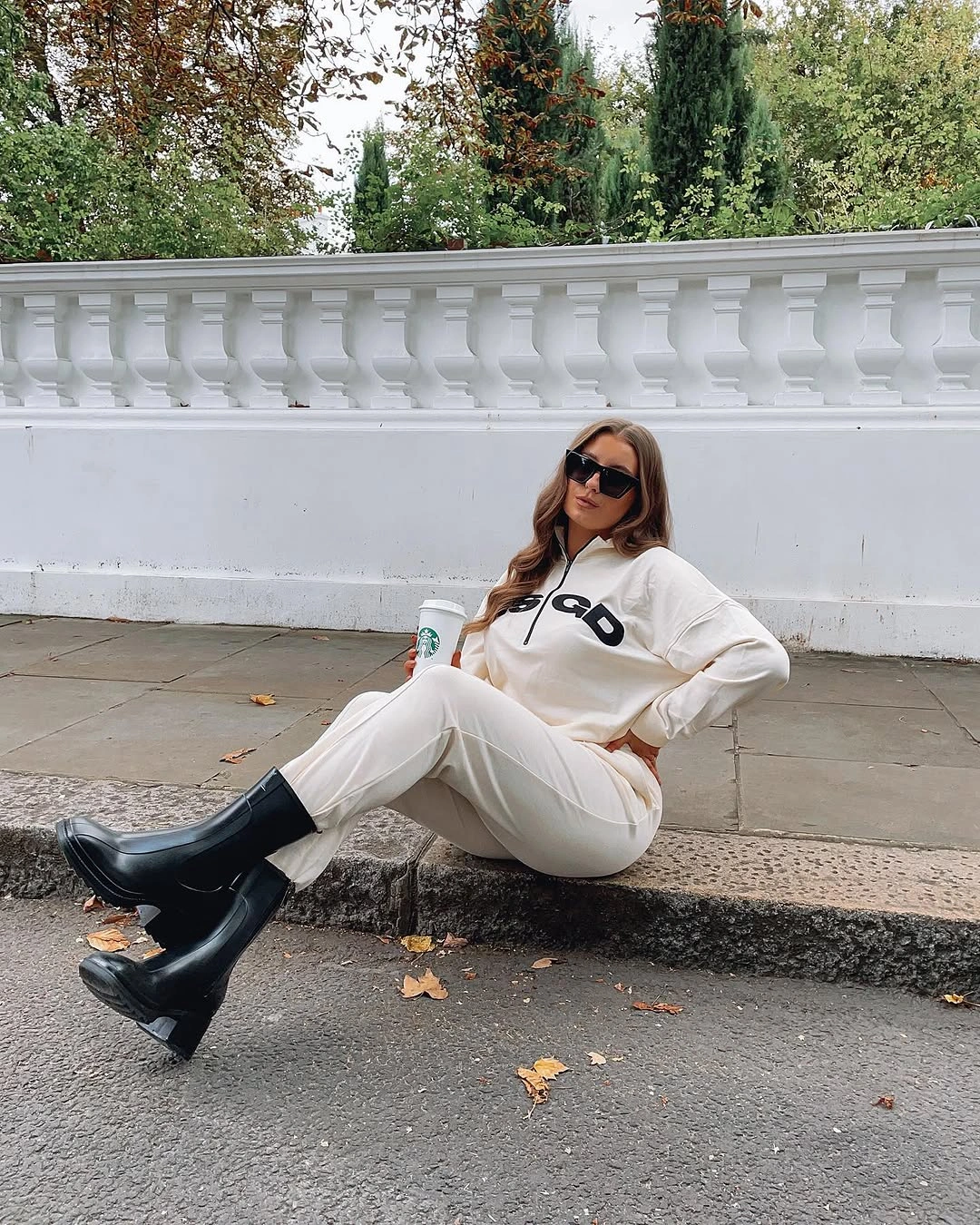 Cream quarter-zip lounge set with chunky black knee-high boots
