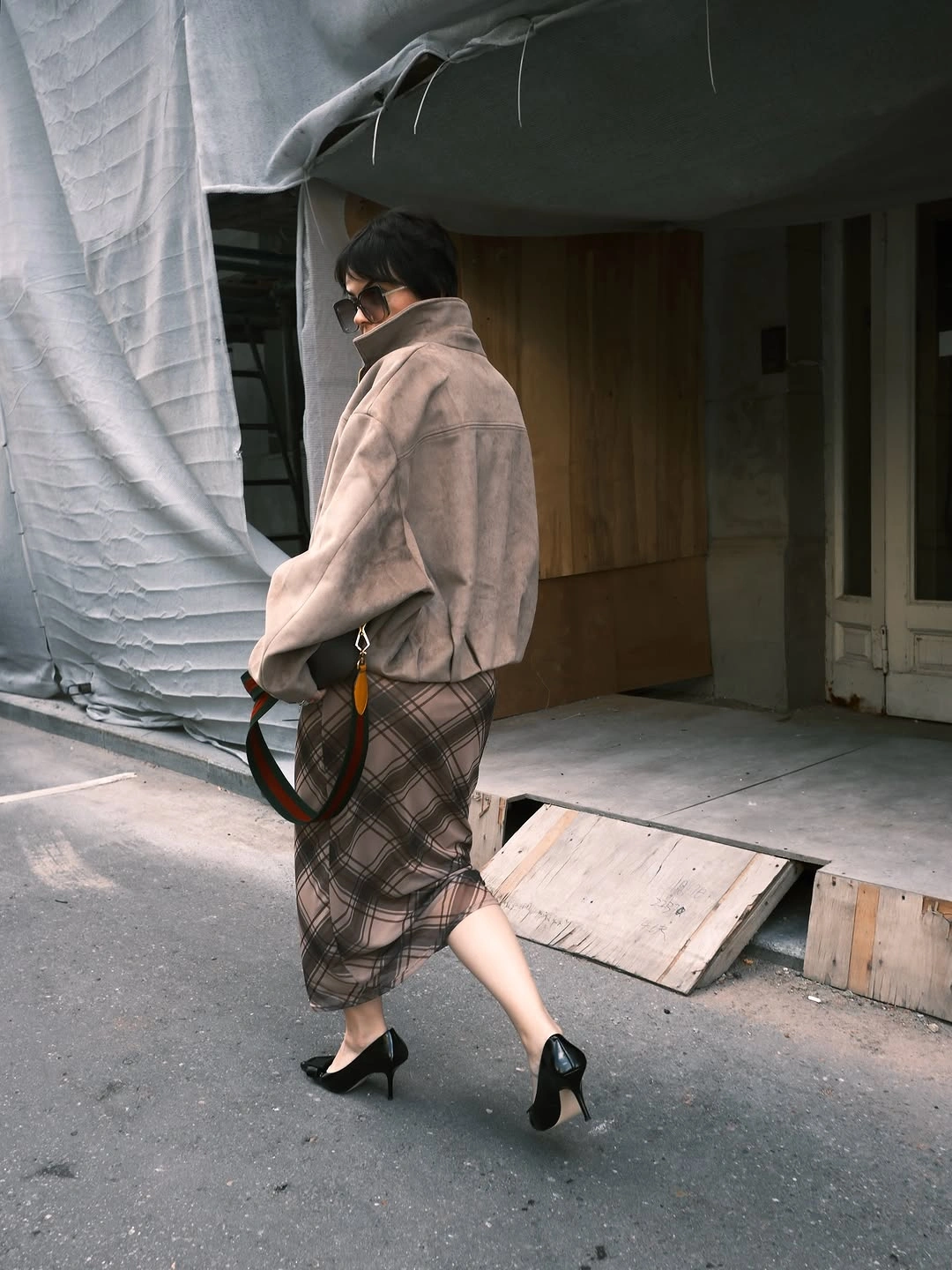 Taupe oversized jacket with sheer plaid midi skirt and black pointed heels