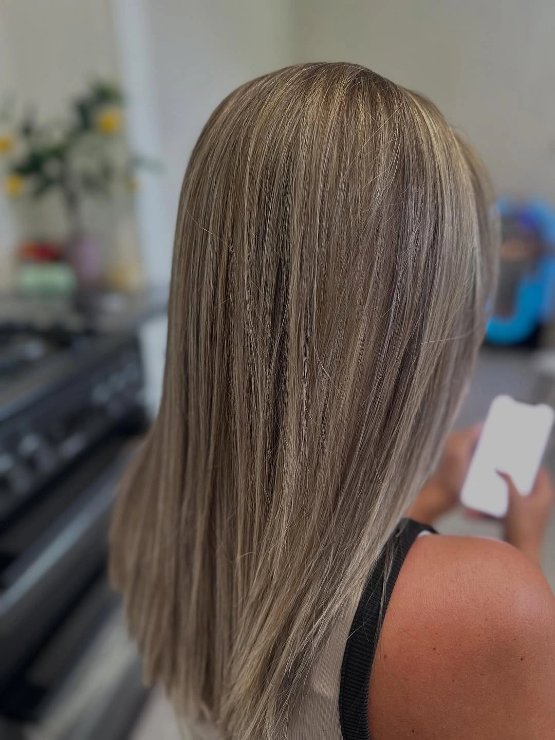 Long ash-beige hair with fine pale ribbons through a neutral base
