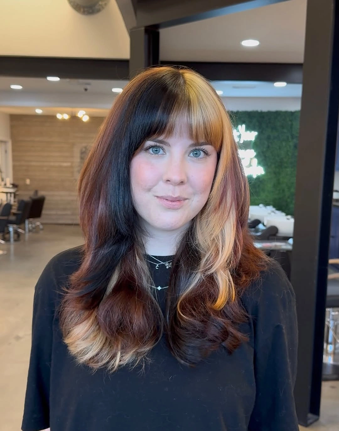 Dark brown waves with a pale blonde split front panel and soft fringe