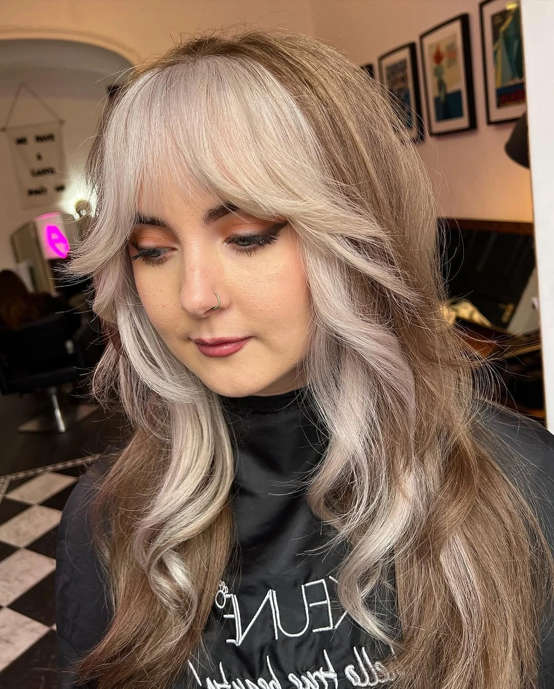 Muted brown waves with broad pale platinum-white face-framing streaks and fringe