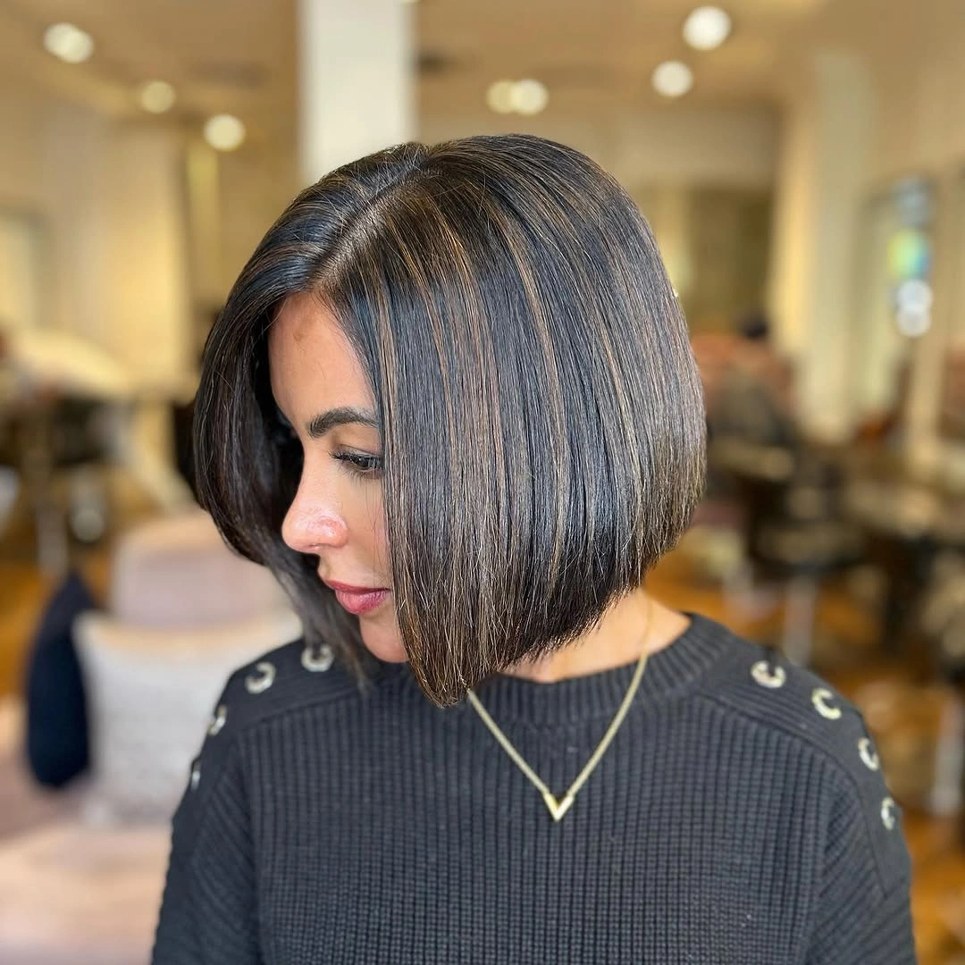 Rounded dark brown bob with fine warm beige-gold ribbons