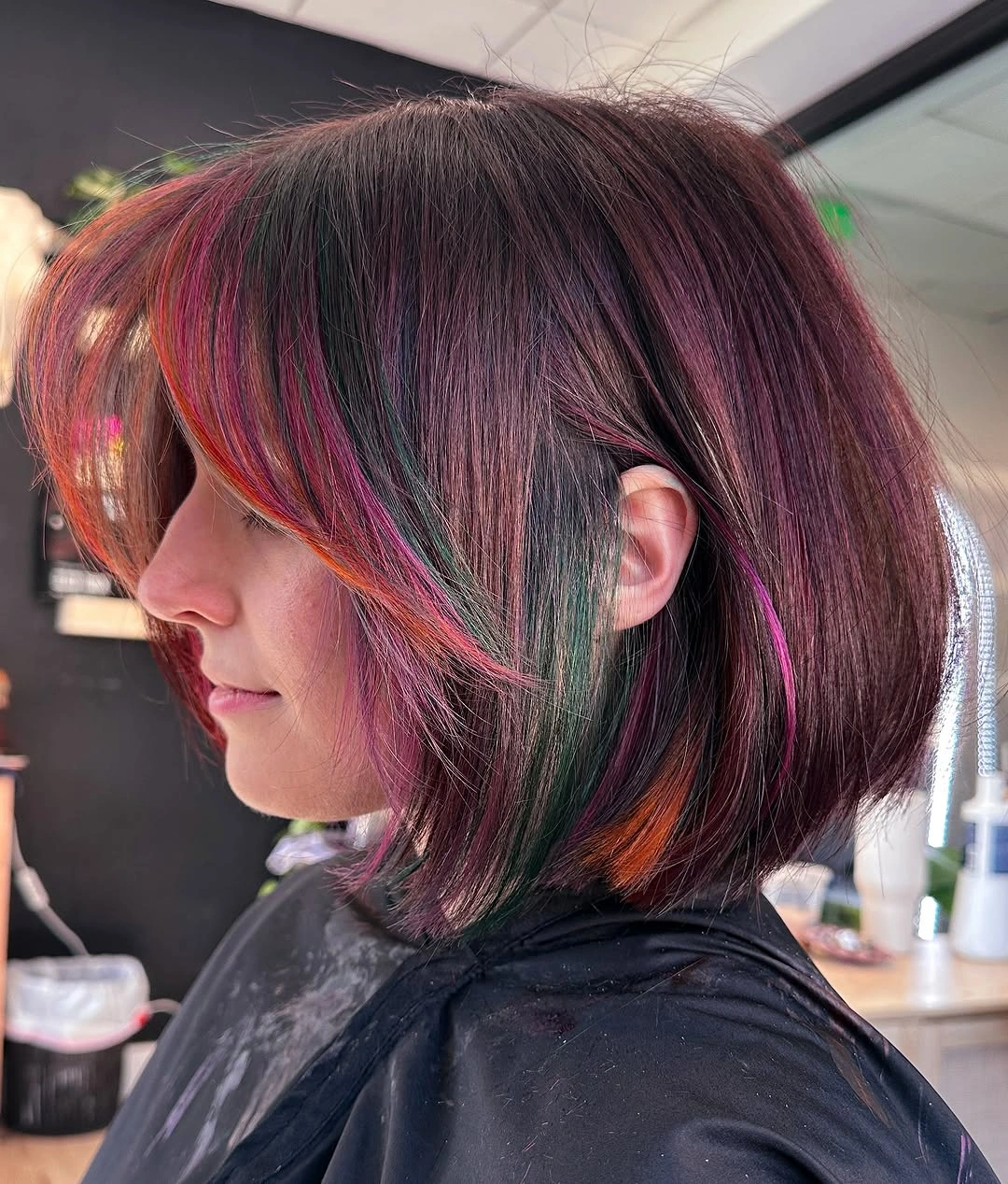 Dark plum bob with red pink orange and deep green accent strands