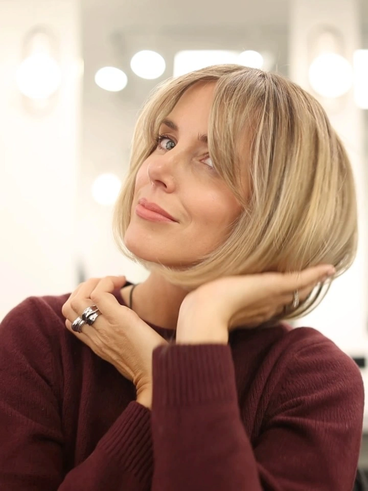 Short light-blonde rounded bob with airy full fringe and curved ends