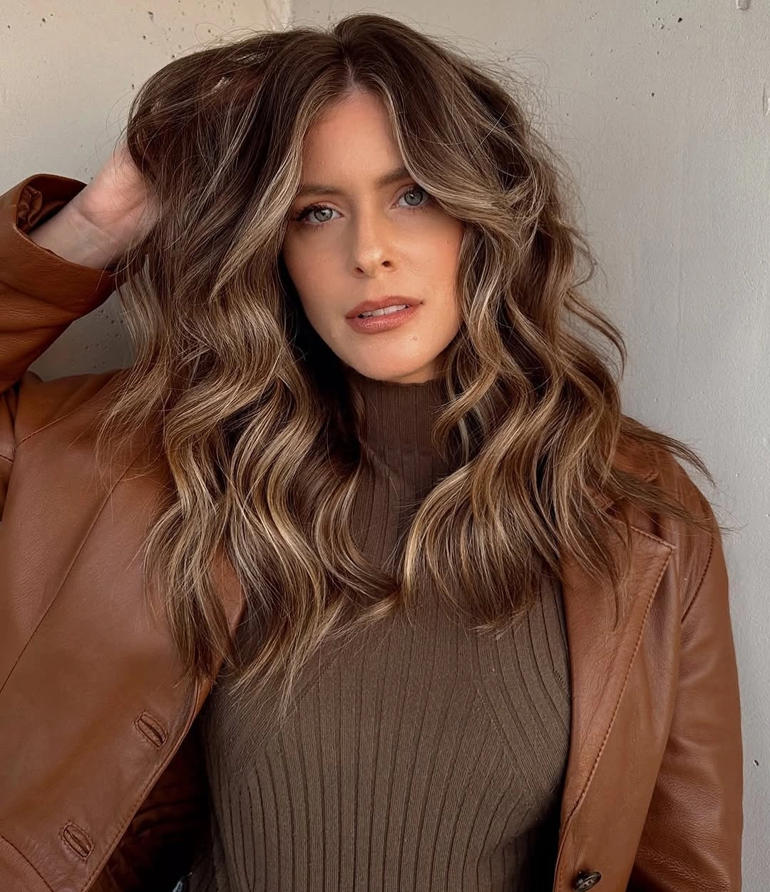 Long wavy brown hair with middle part and bright face-framing pieces