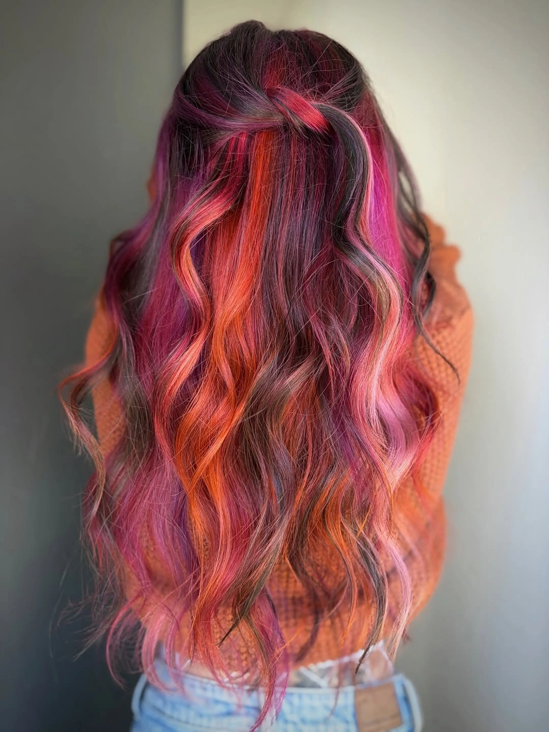 Very long dark wavy hair with colorful streaks and half-up twist