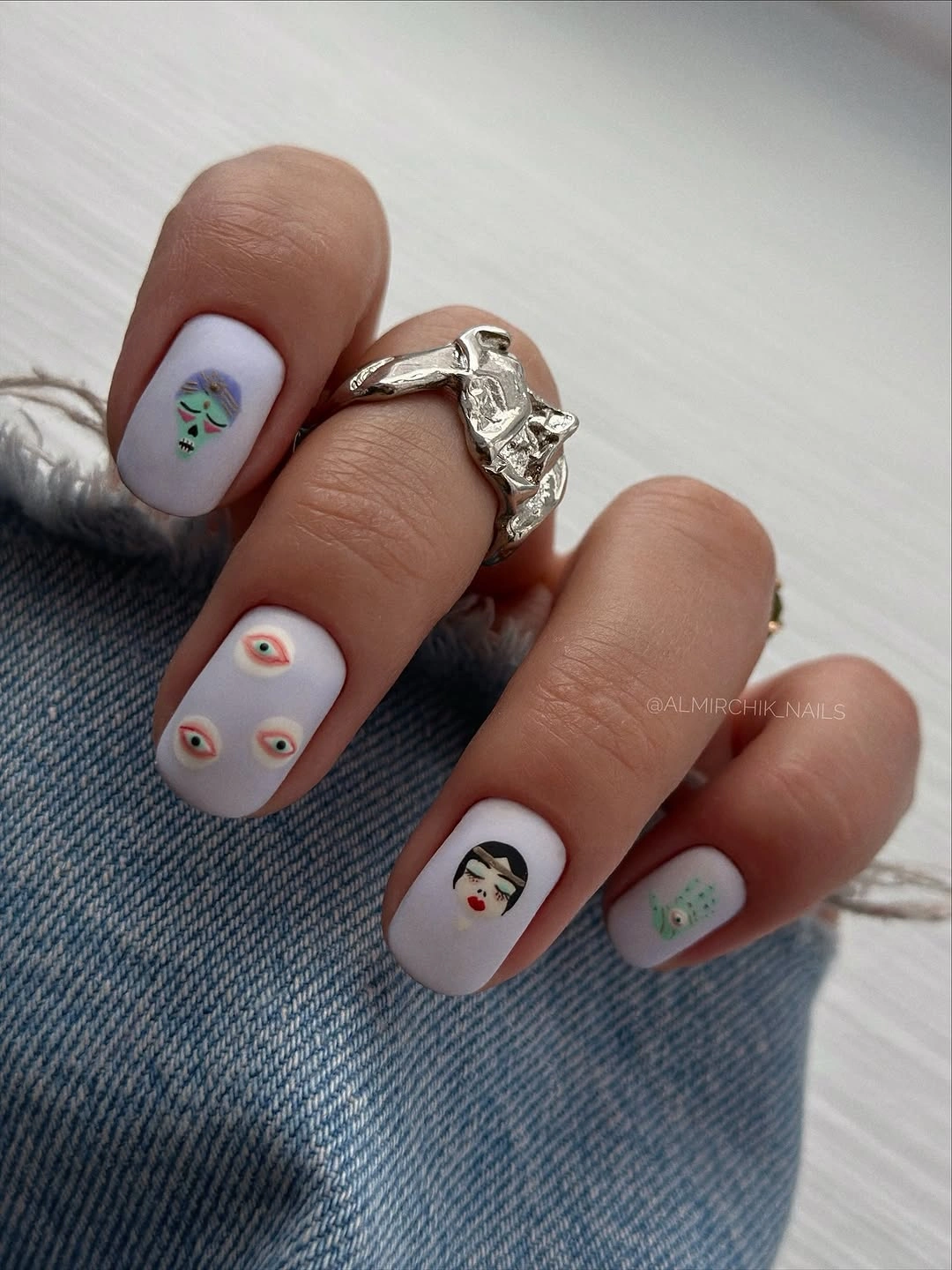 Short white square nails with green orange and black Halloween icons