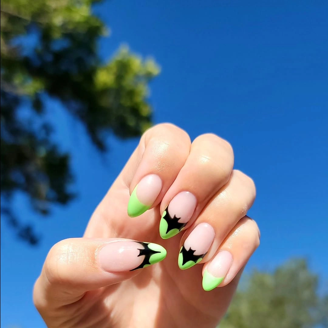 Pale pink almond nails with bright lime green tip accents