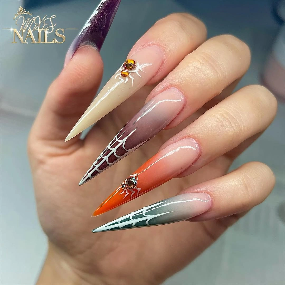 Long nude stiletto nails with orange burgundy green black tip panels