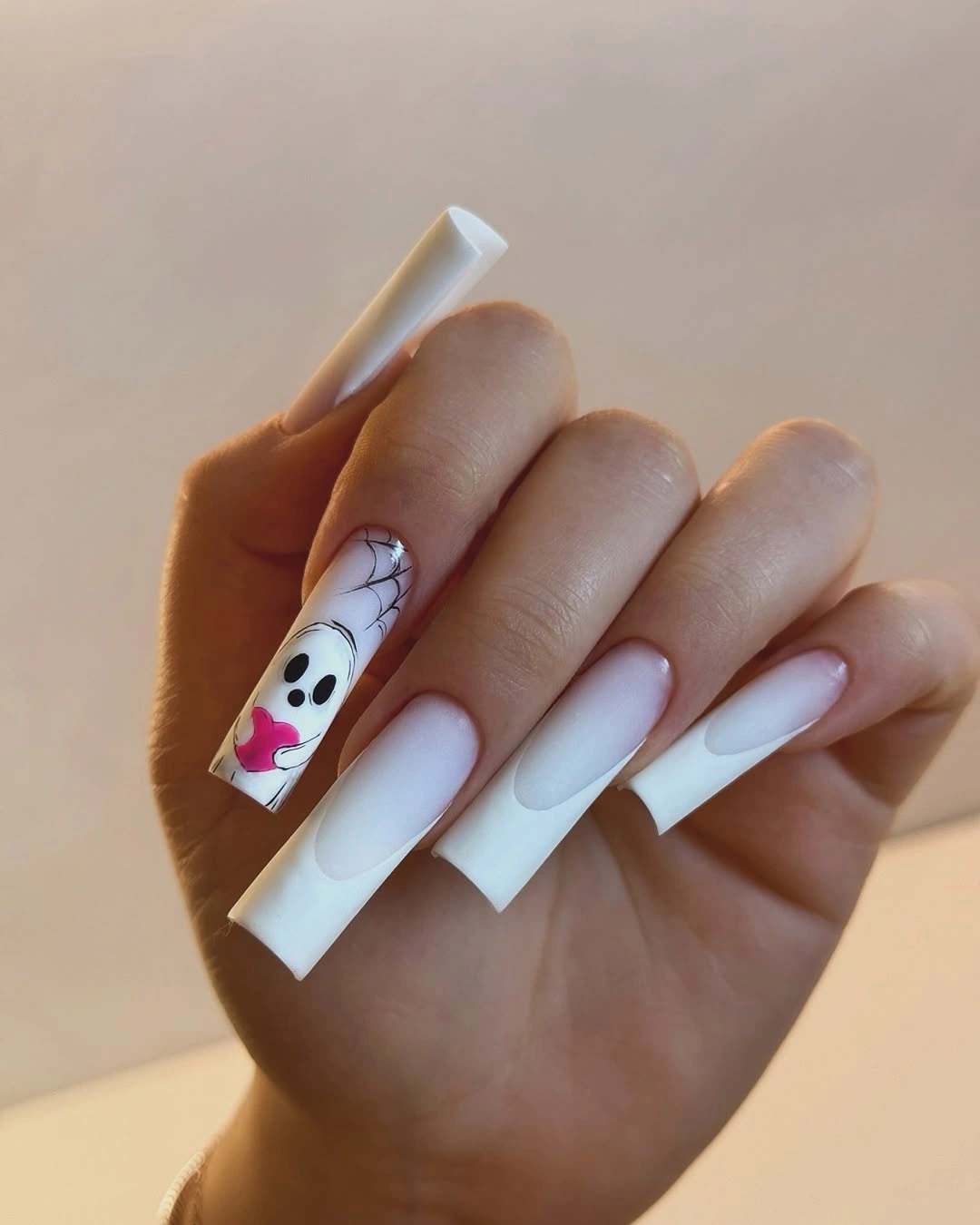Long square white ombre nails with black web and ghost detail