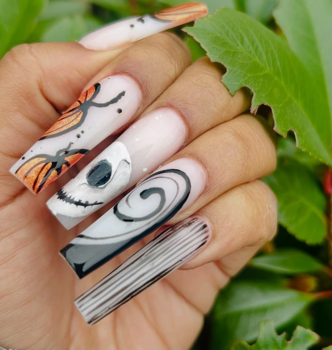 Long white square nails with black spiral face and orange illustrated art