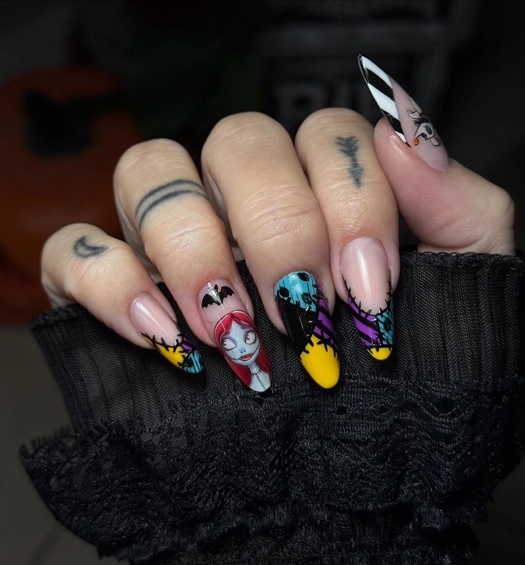 Pink and black almond nails with yellow blue cartoon Halloween accents
