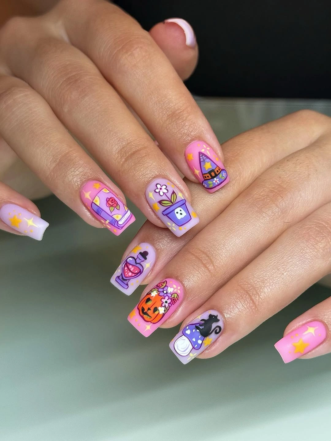 Pastel square nails with colorful cartoon Halloween icons and stars