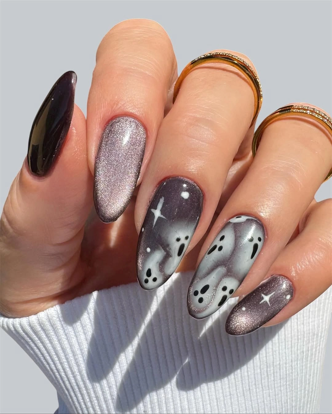 Long black gray and silver nails with white ghost faces and stars