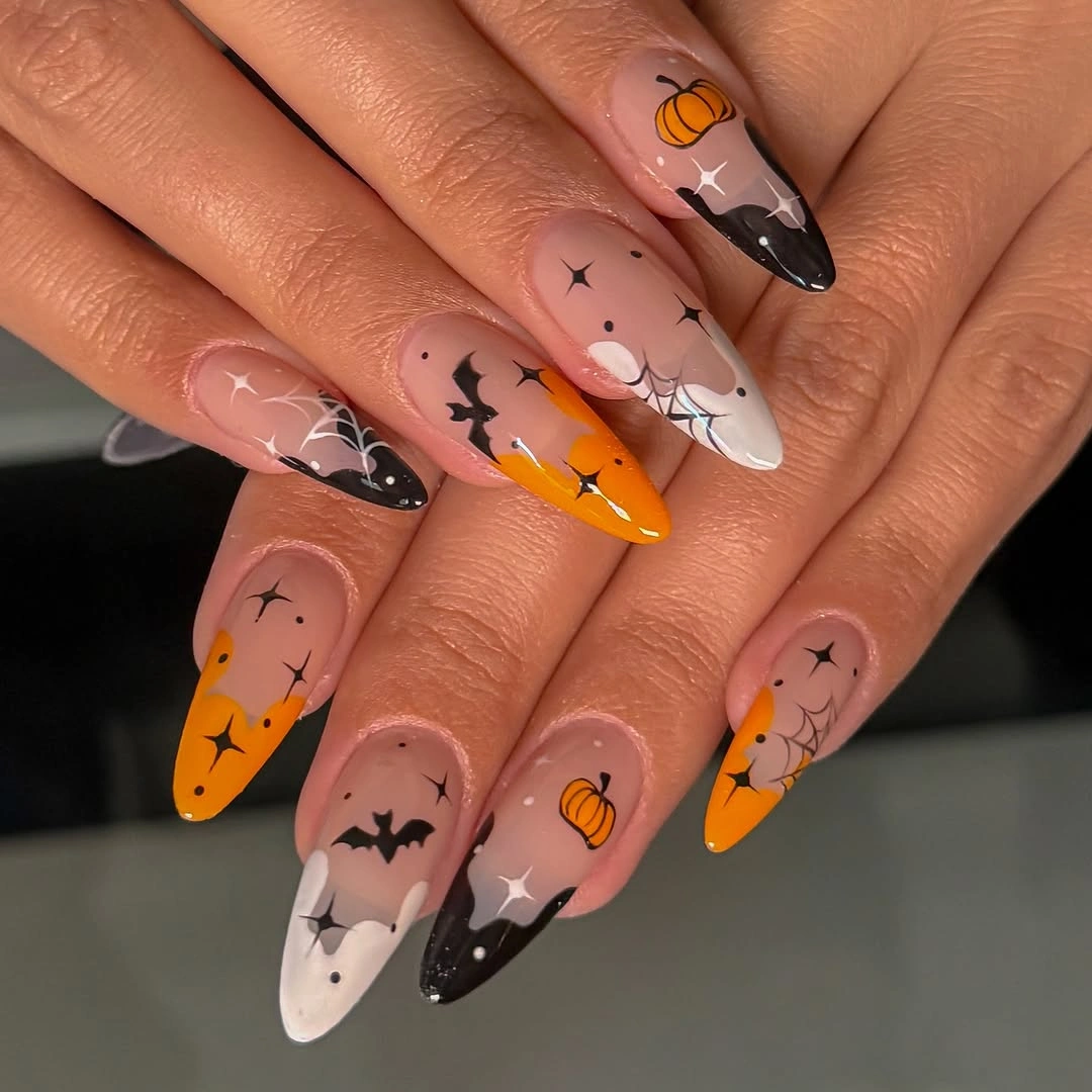 Long almond nails with orange pumpkin bats ghosts and dark tips