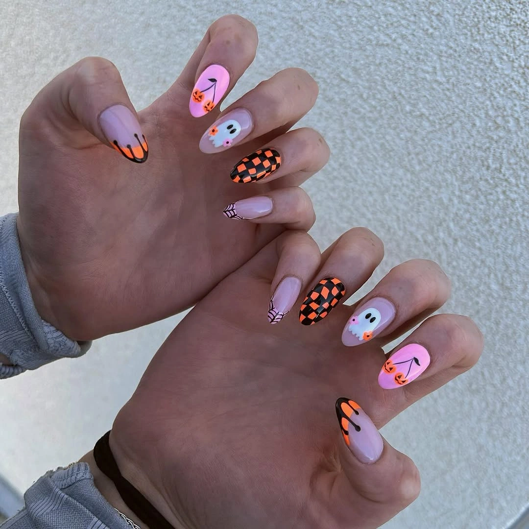 Short pastel square nails with pumpkins ghosts checkerboard and small flowers
