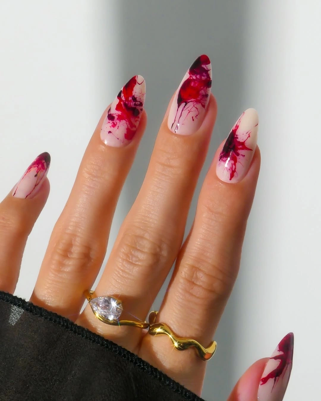 Long pink stiletto nails with red burgundy marbled swirls
