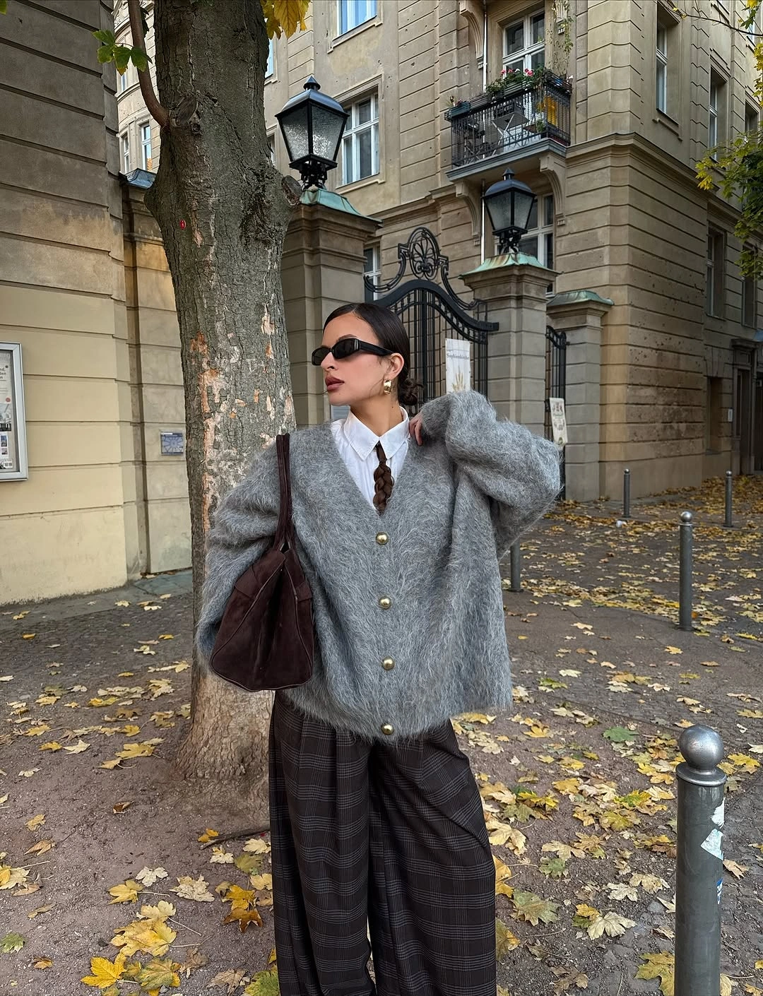 Gray textured sweater with brown plaid wide trousers and burgundy bag