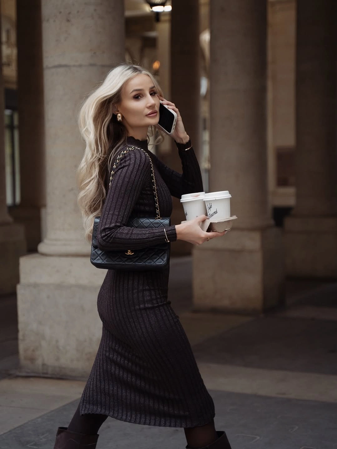 Black ribbed long sleeve dress with tights and quilted shoulder bag