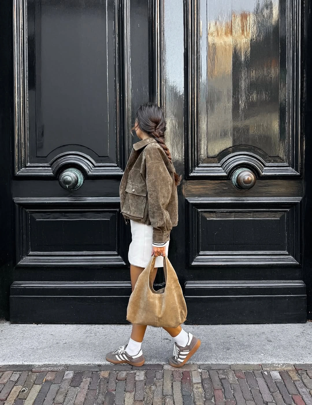Beige jacket white jeans striped socks spotted sneakers and cream handbag