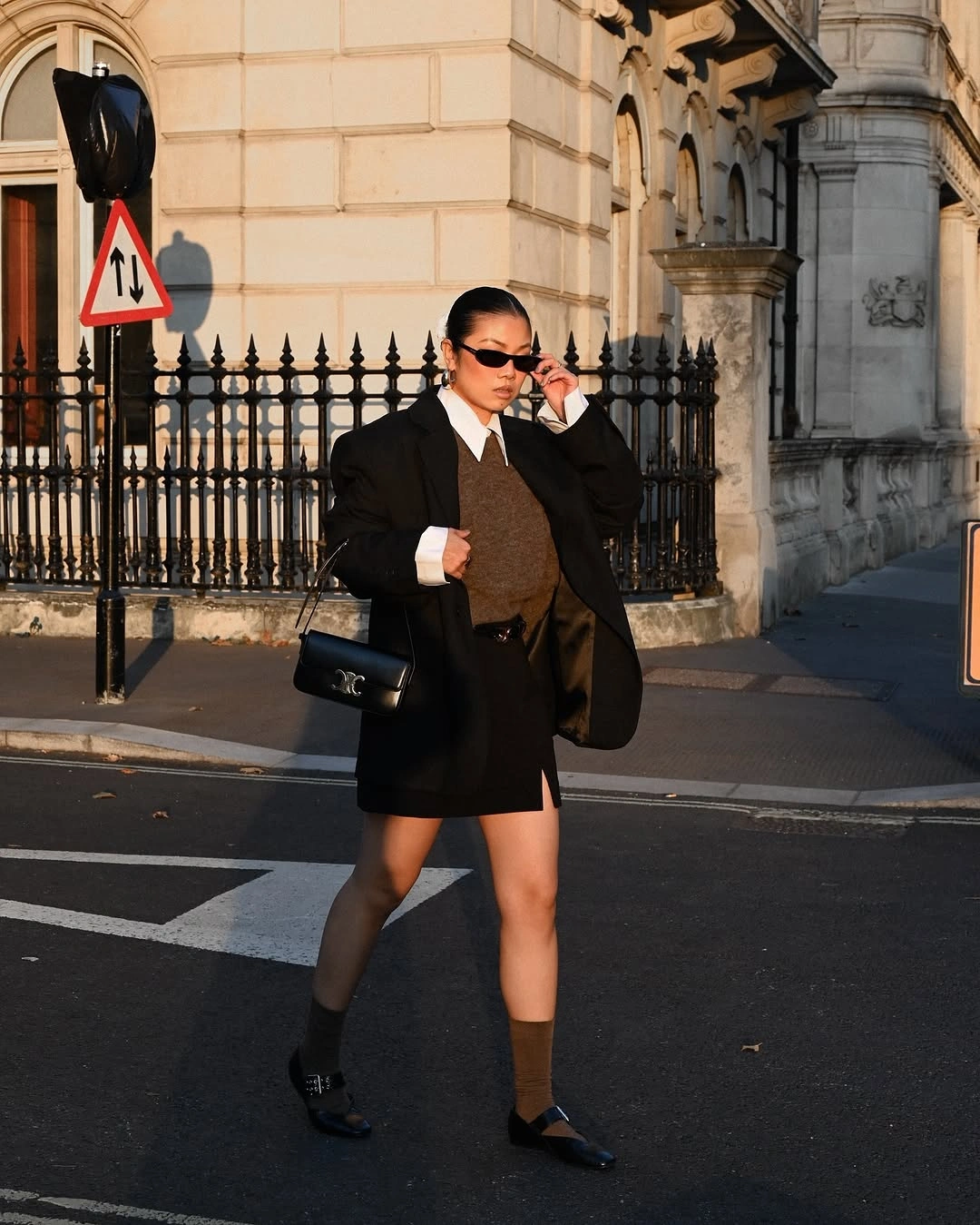 Black oversized blazer with white collar brown knit mini skirt and loafers