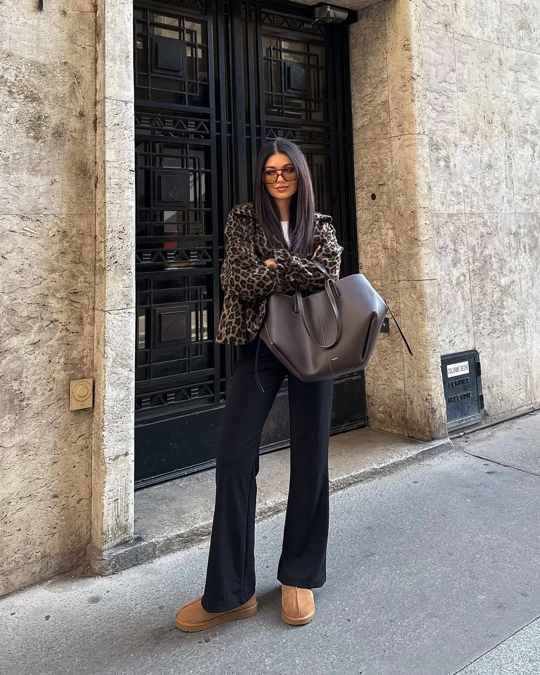Animal print jacket with black flared trousers and large bag