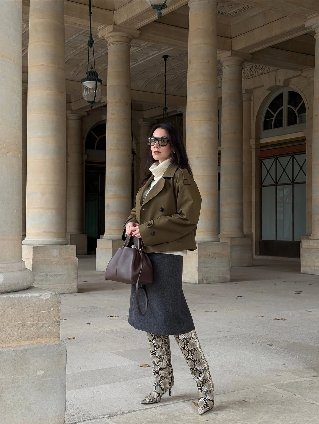 Olive blazer with dark midi skirt patterned knee boots and brown bag