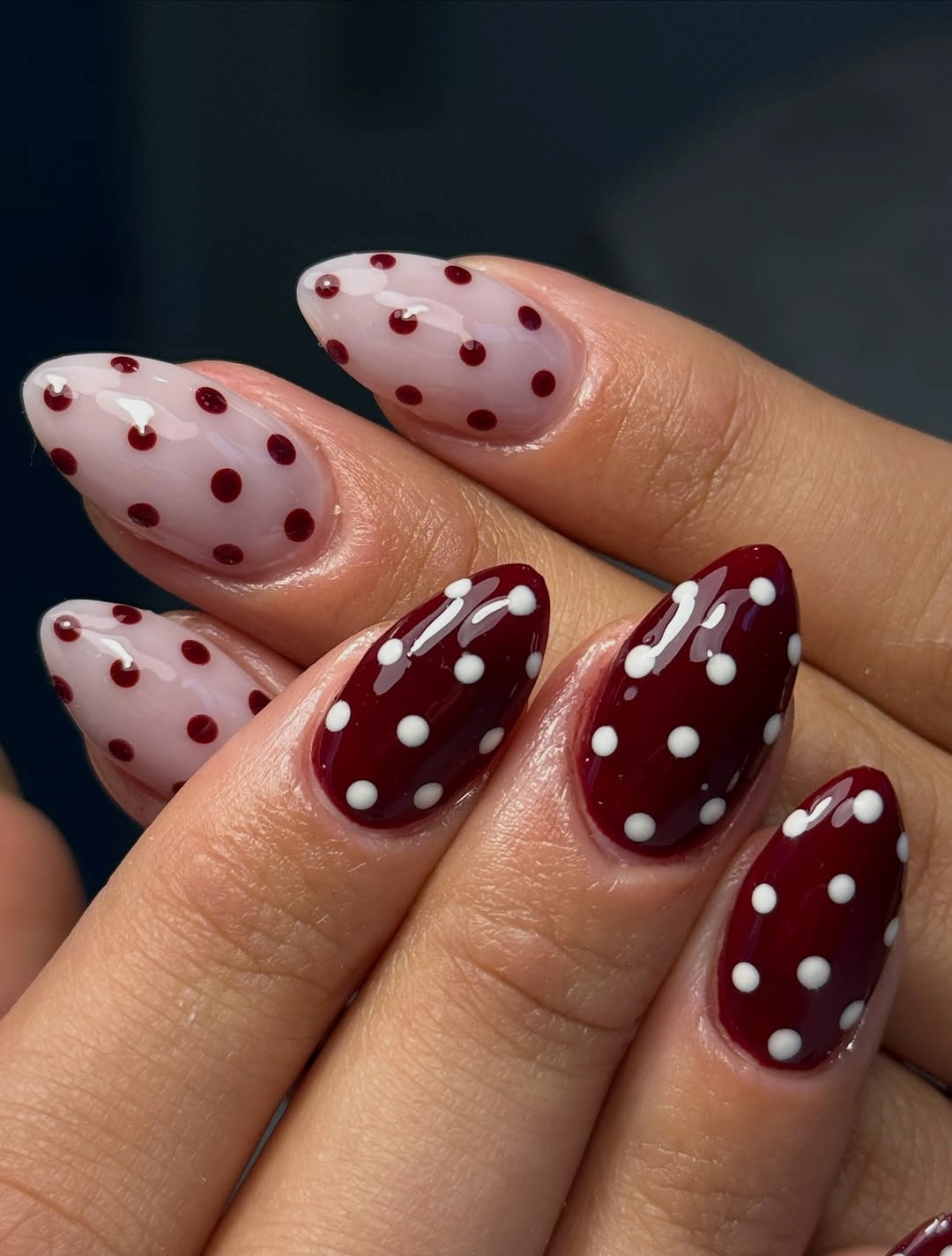 Sheer pink and burgundy nails with contrasting polka dot details