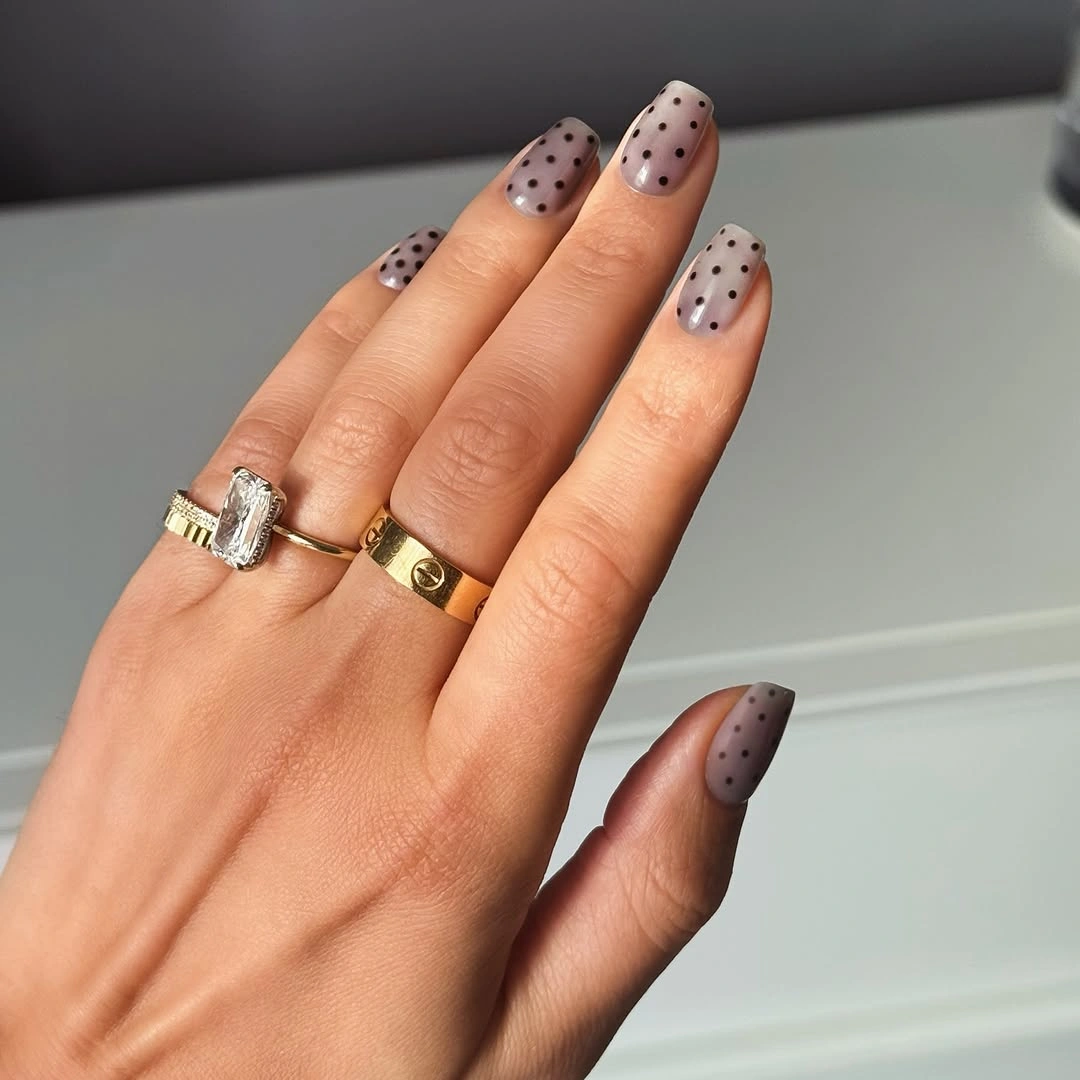 Short gray lilac oval nails with evenly spaced black dots