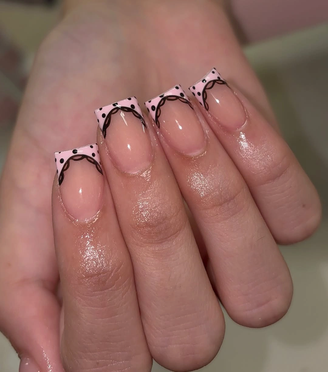 Long pink square nails with black dotted French tip frames