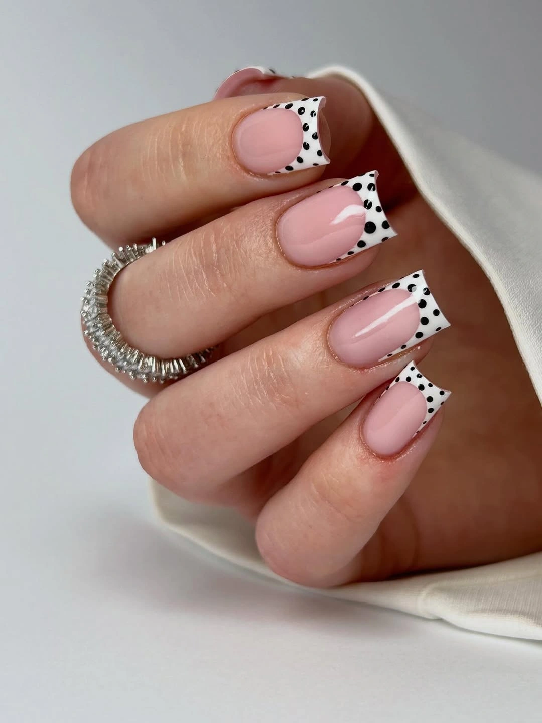 Soft pink square nails with white black spotted French tips