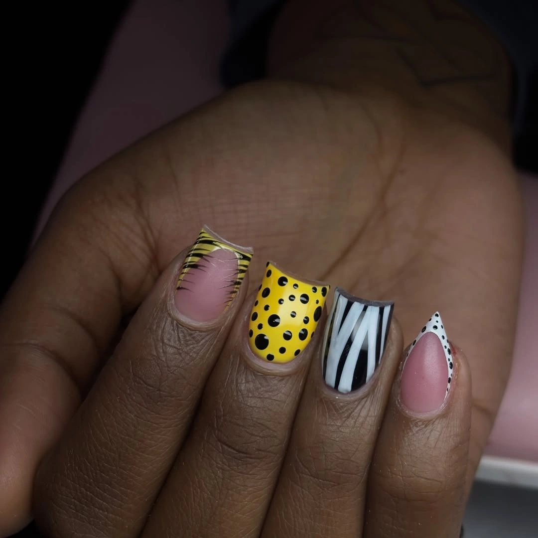 Short yellow pink striped and dotted mixed nails