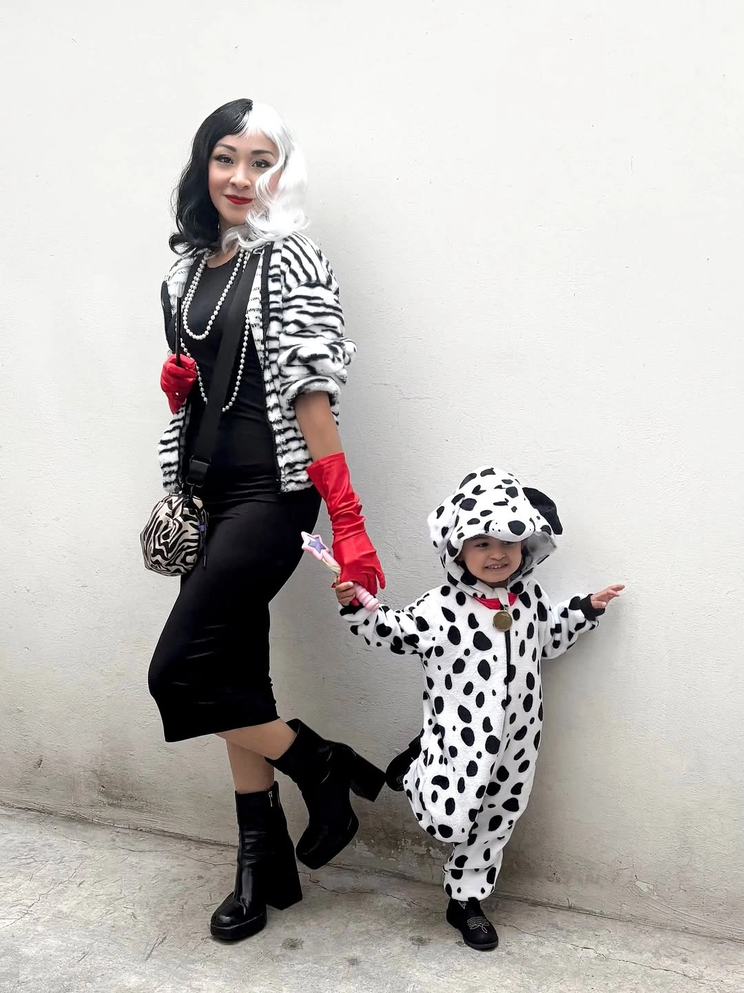 Black-and-white coordinated Halloween duo with red gloves and spotted child costume