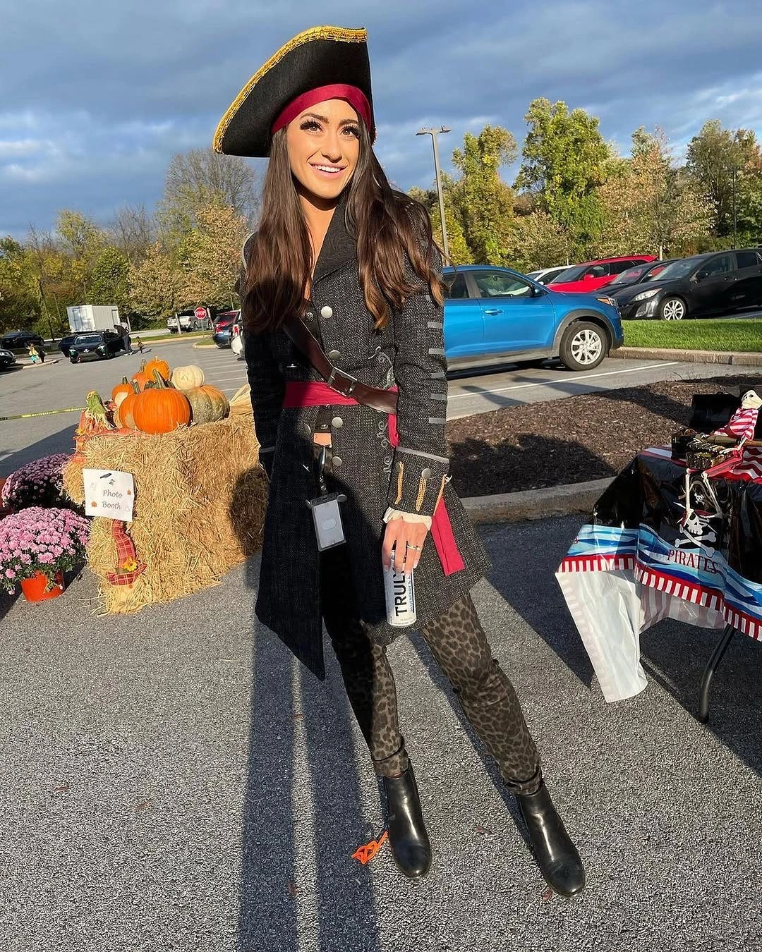Black pirate-inspired Halloween outfit with striped head accent fitted trousers belt and boots
