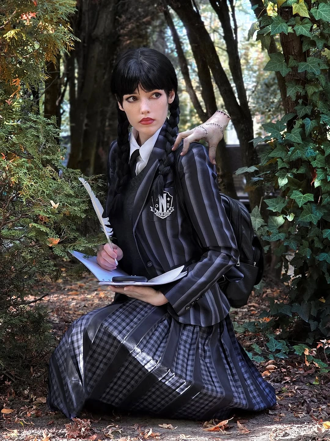 Dark academic Halloween dress with white collar cuffs patterned tights and book prop