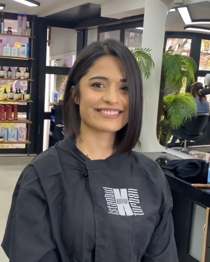 Front-facing brunette medium bob with slightly longer front side