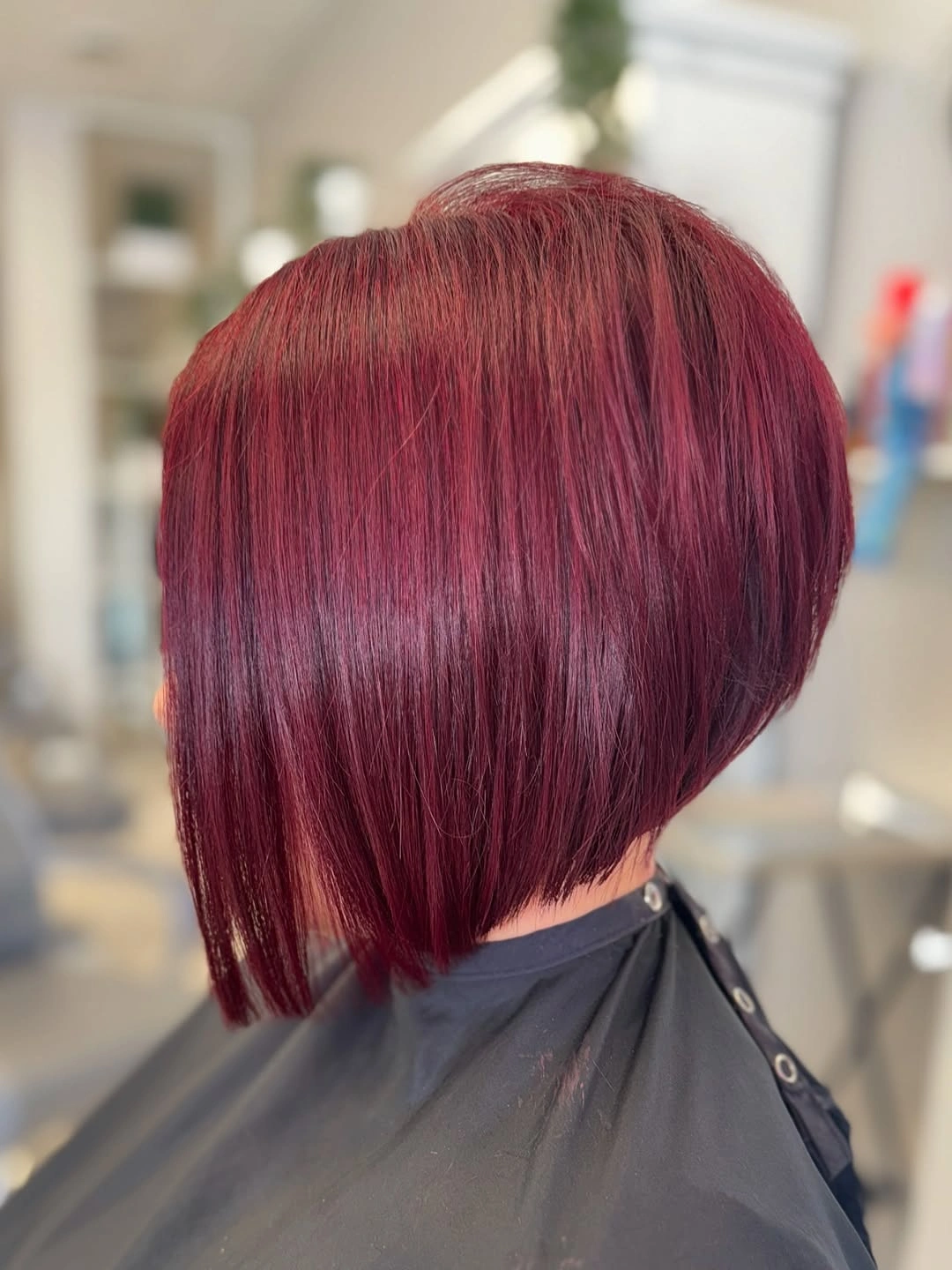 Deep burgundy angled bob with glossy rounded back