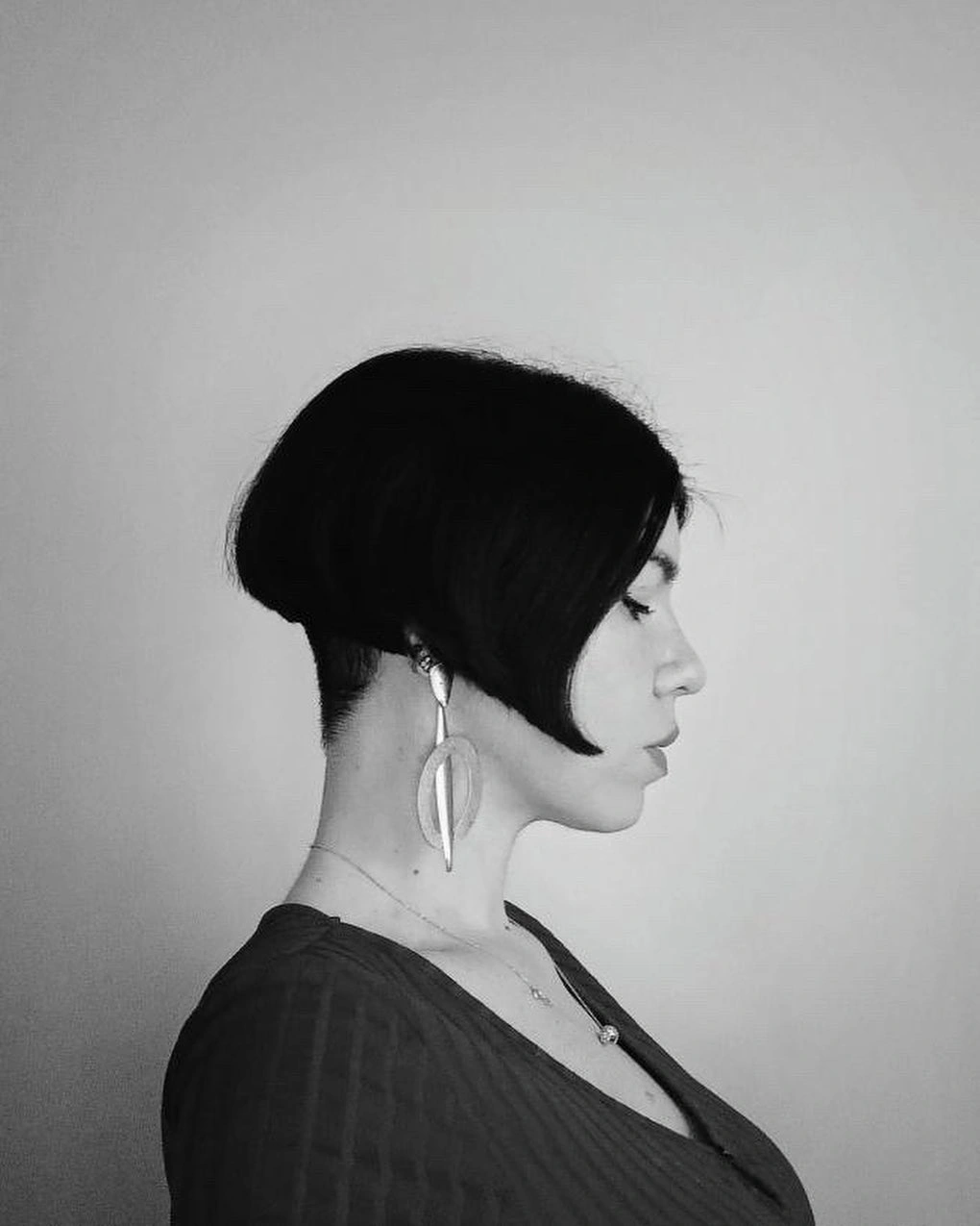 Monochrome side profile bob with cropped nape and long front point