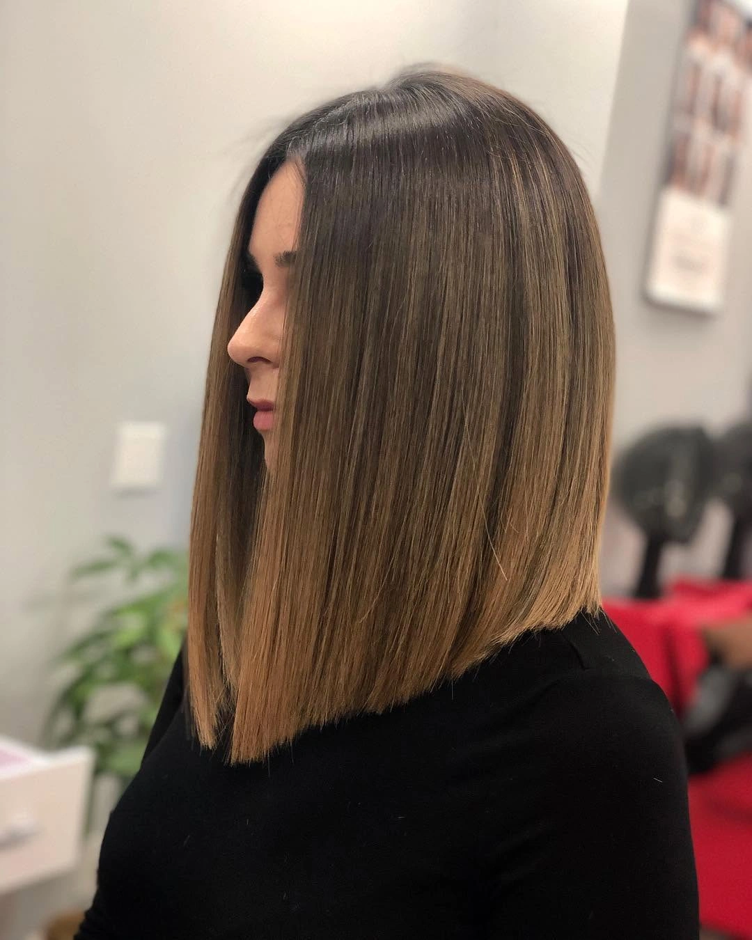 Brunette long bob with subtle highlights and forward angle