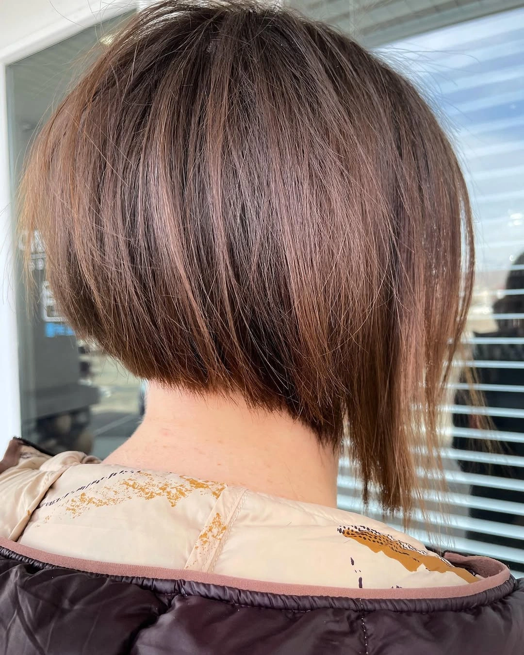 Brunette short stacked A-line bob with longer front section