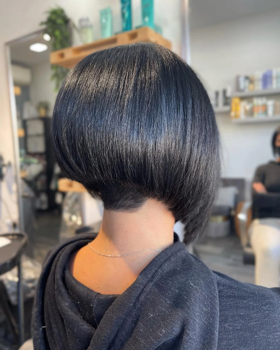 Rear view glossy dark bob with close tapered nape